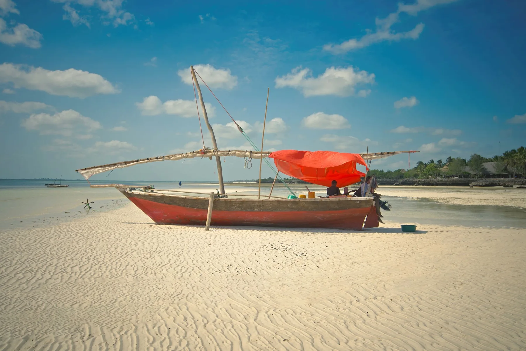 Traditional wooden dhow resting on a Zanzibar beach
