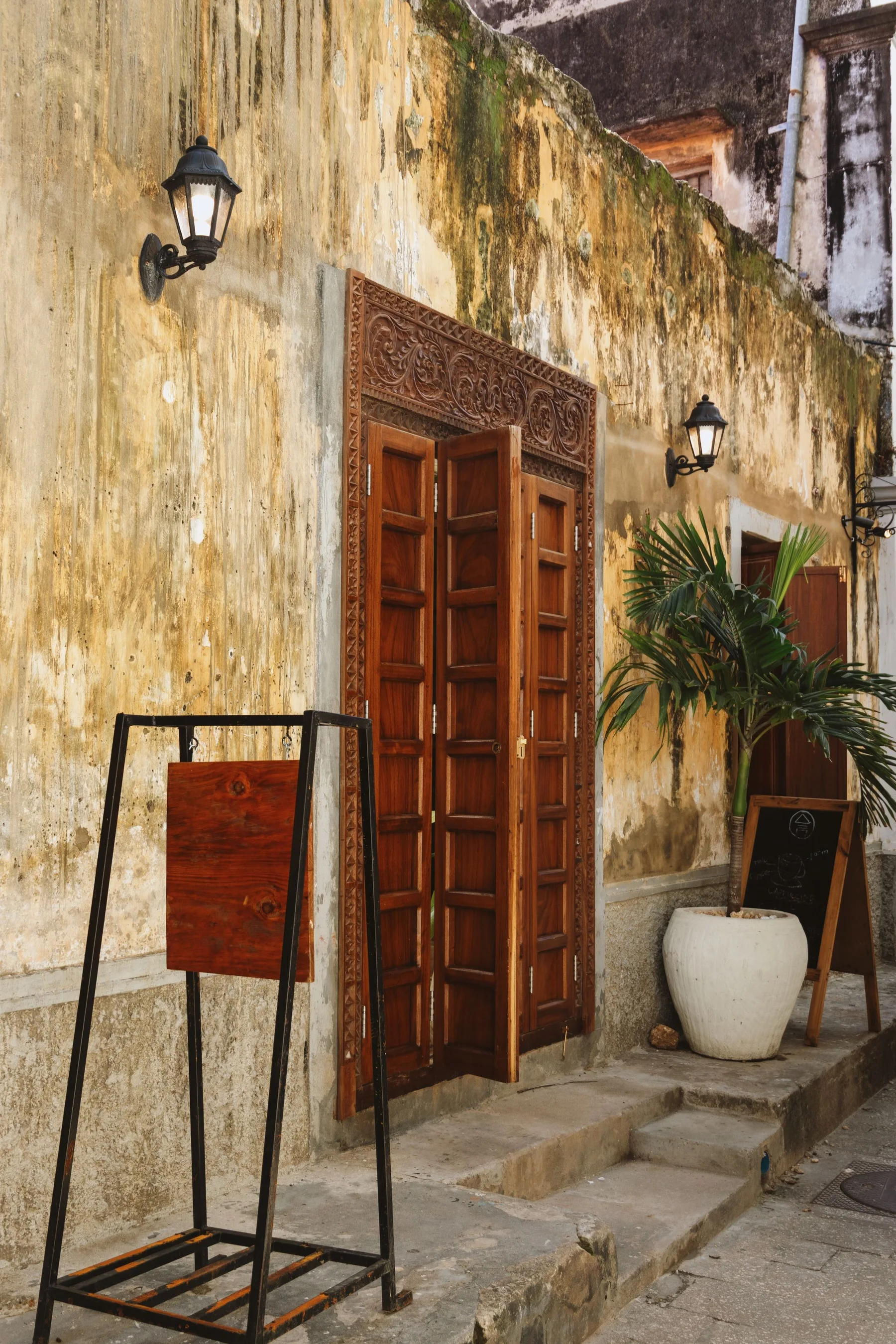 Carved wooden doorway and warm stone facade in Stone Town, Zanzibar